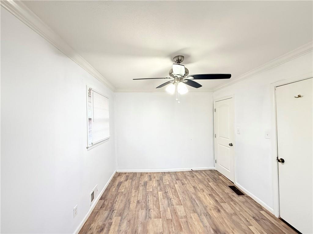 3276 Pin Oak Circle Atlanta, GA 30340 - Photo 10 of 22 an empty room with wooden floor fan and windows