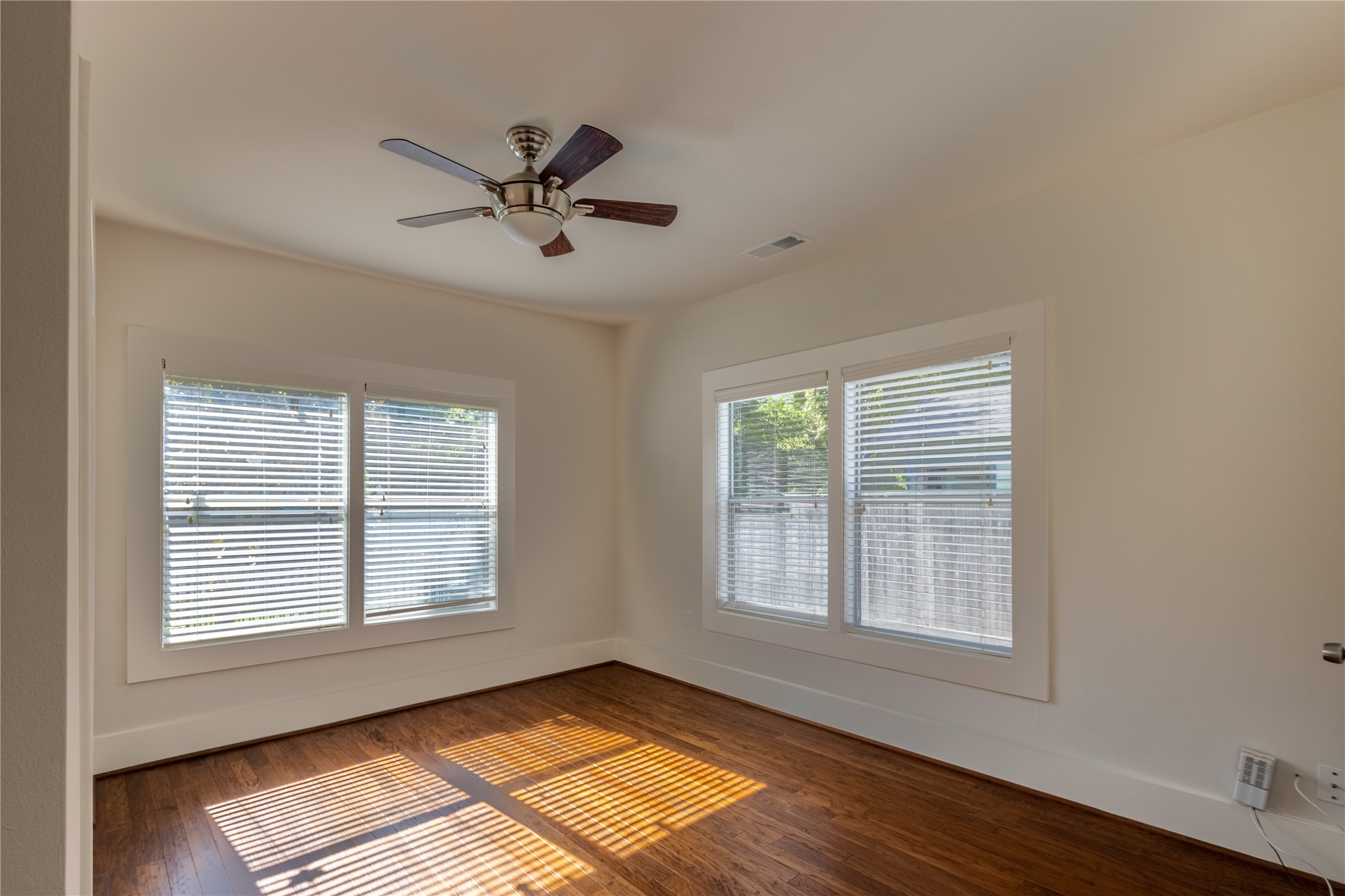2009 Singleton Street Houston, TX 77008 - Photo 15 of 24 a view of an empty room with wooden floor and a window