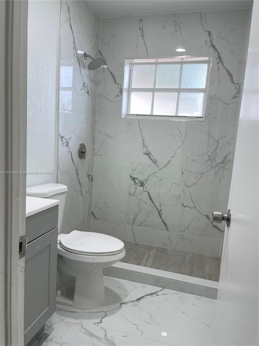 5261 Northwest 1st Street, Unit FRONT Miami, FL 33126 - Photo 11 of 14 a bathroom with a toilet and a shower