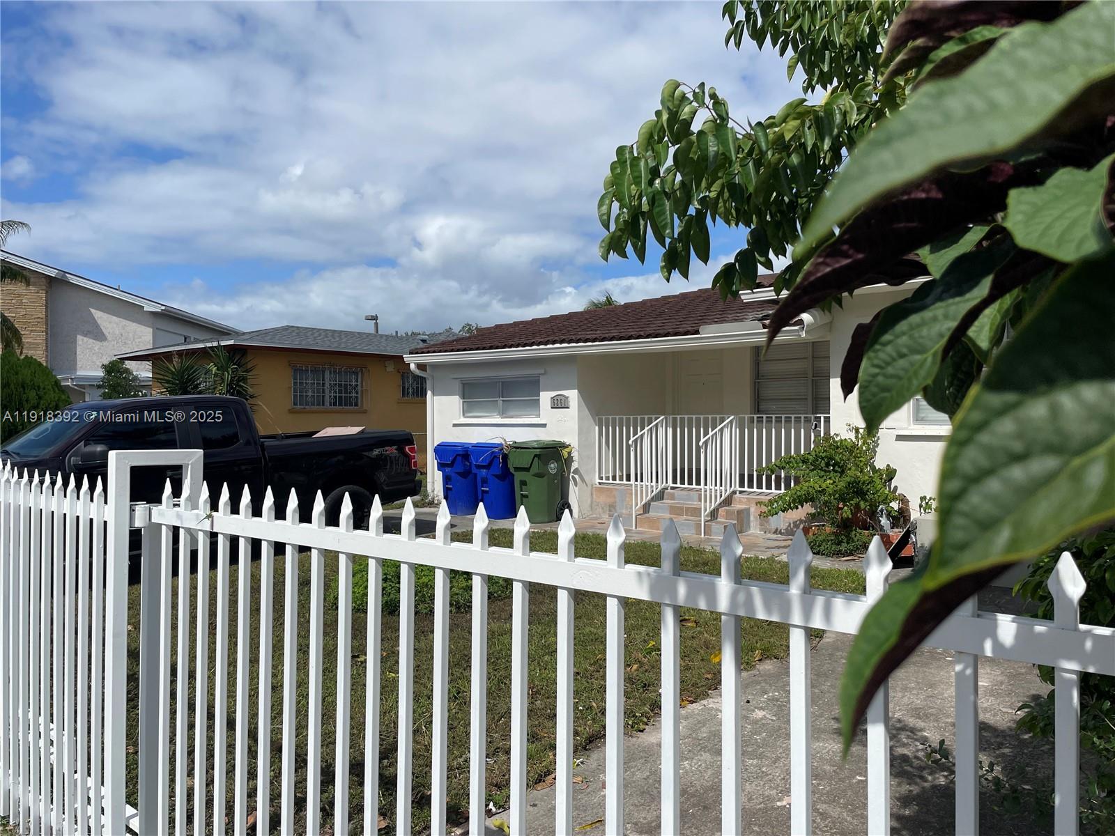 5261 Northwest 1st Street, Unit FRONT Miami, FL 33126 - Photo 2 of 14 a view of a house with wooden fence
