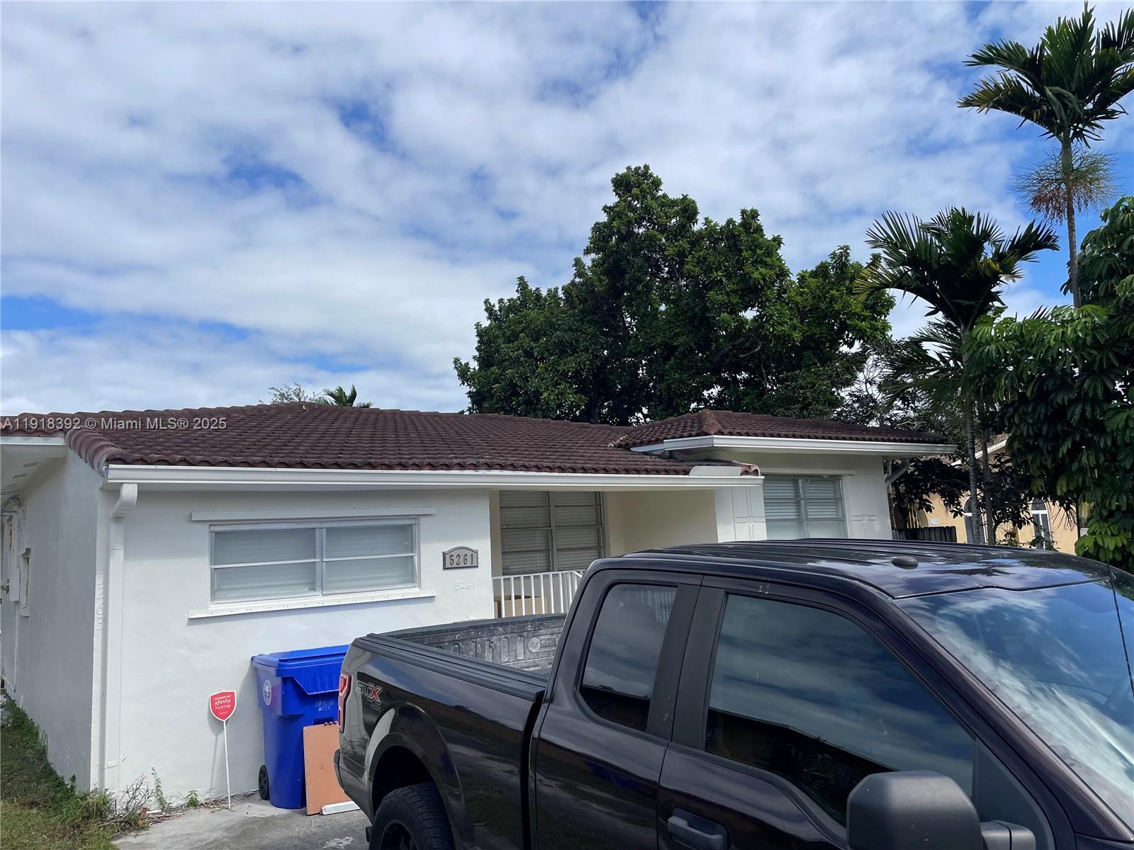 5261 Northwest 1st Street, Unit FRONT Miami, FL 33126 - Photo 3 of 14 a view of house with outdoor space and car parked