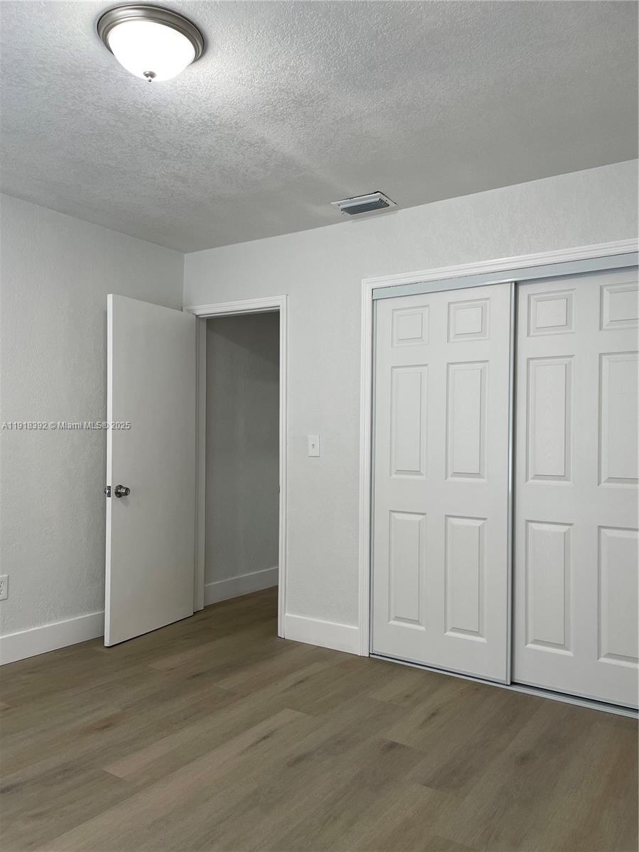 5261 Northwest 1st Street, Unit FRONT Miami, FL 33126 - Photo 9 of 14 a view of an empty room