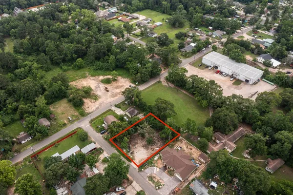 an aerial view of a house with a yard