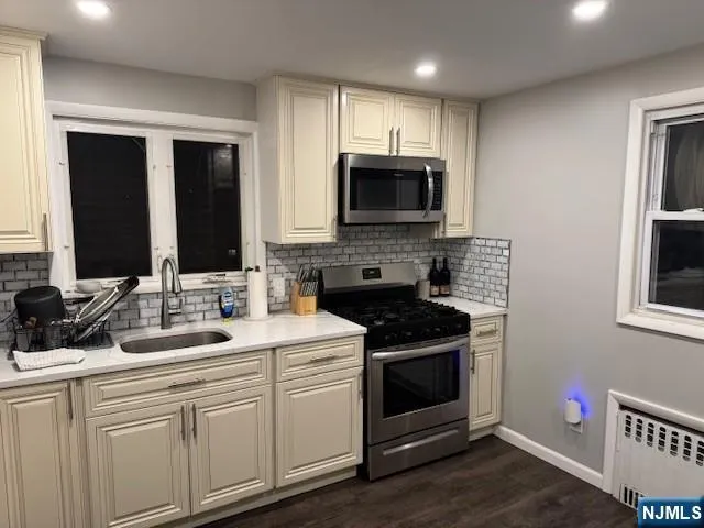 a kitchen with a sink stove and microwave