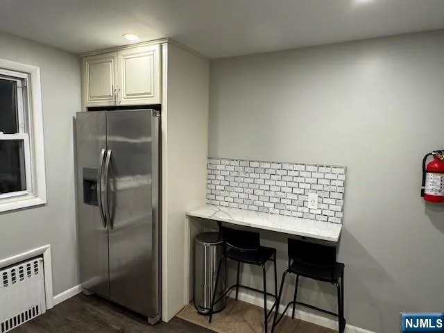 a kitchen with kitchen island a counter top space cabinets and stainless steel appliances
