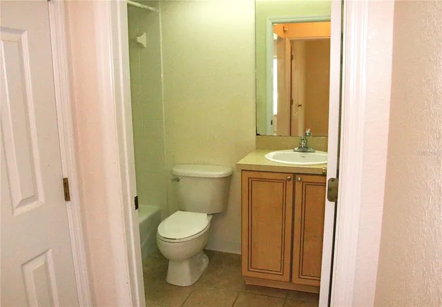 a bathroom with a sink toilet and a mirror