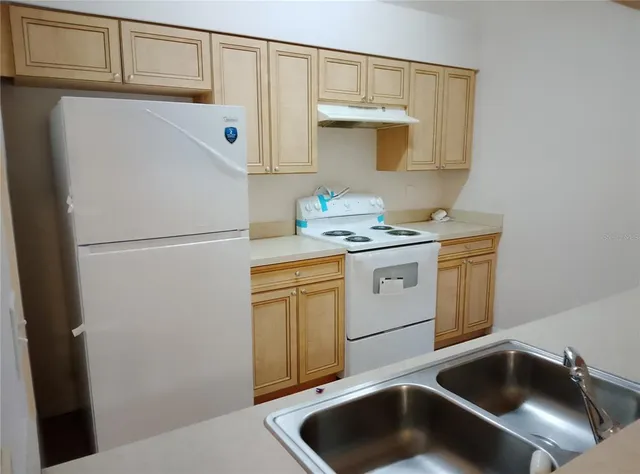 a kitchen with stainless steel appliances a stove and a refrigerator