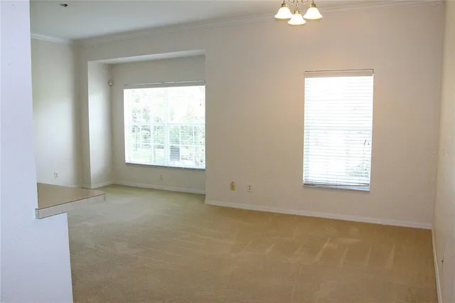 a view of a dining room with furniture and window