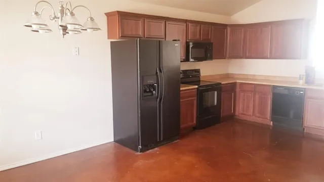 a kitchen with stainless steel appliances a refrigerator and a stove top oven