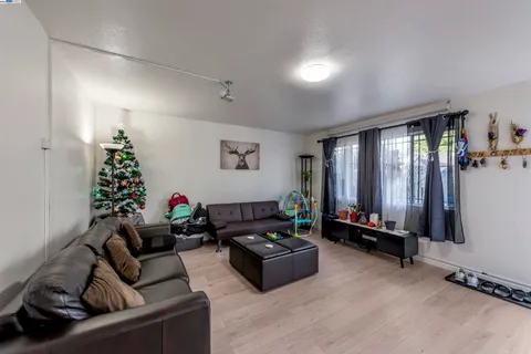 a living room with furniture gym equipment and a large window