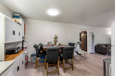a dining room with furniture and wooden floor