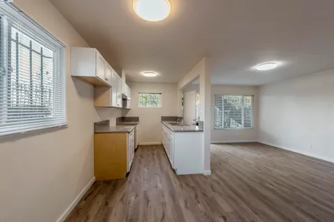 a kitchen with sink cabinets and wooden floor