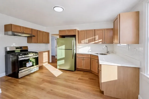 a kitchen with a refrigerator and a sink