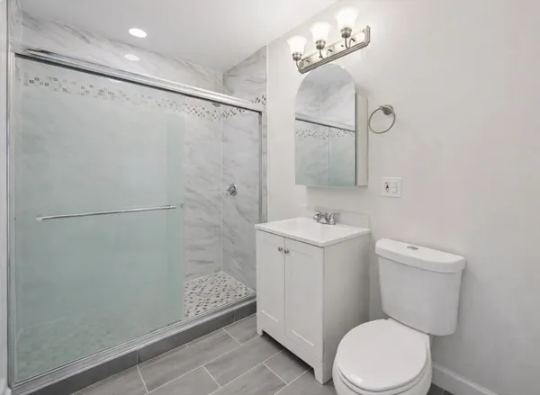 a white toilet sitting next to a bathroom sink
