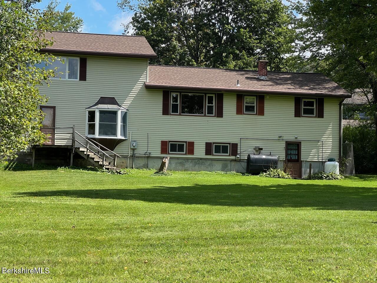 72 Brunell Avenue Lenox, MA 01240 - Photo 19 of 27 a front view of a house with a garden