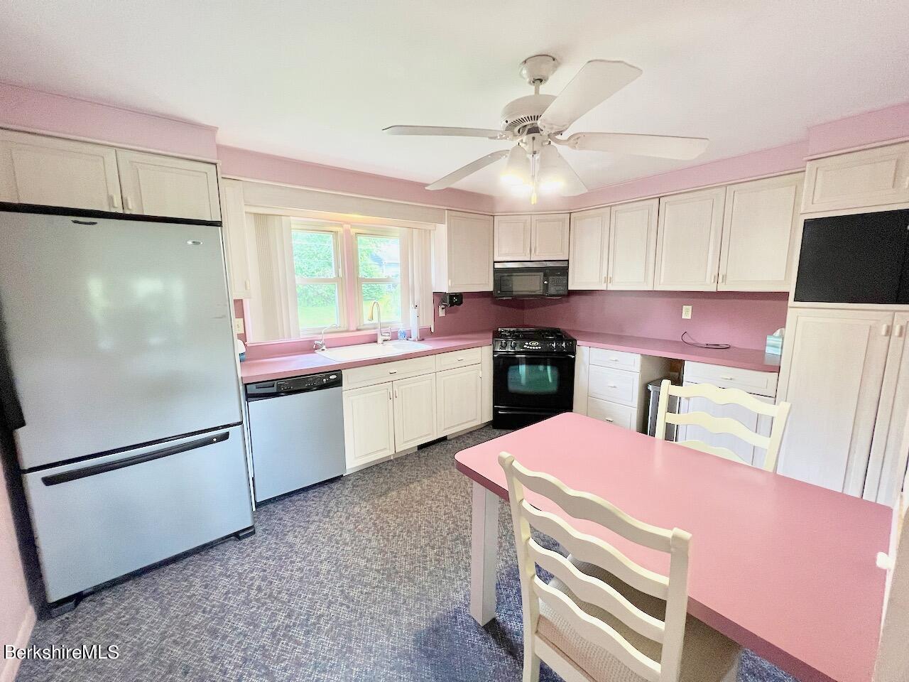 72 Brunell Avenue Lenox, MA 01240 - Photo 4 of 27 a kitchen with a refrigerator a sink cabinets and wooden floor