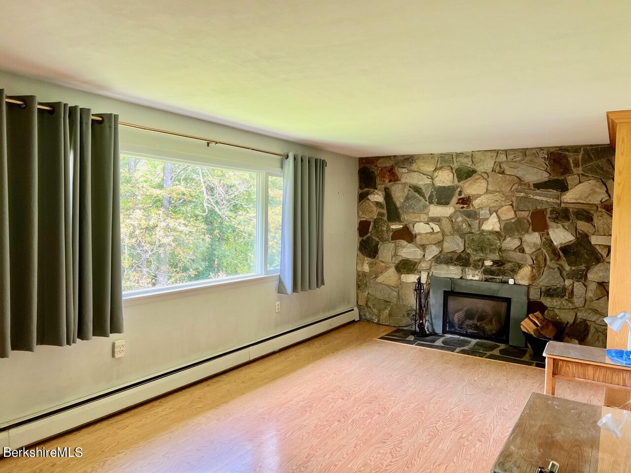 72 Brunell Avenue Lenox, MA 01240 - Photo 5 of 27 a room with a fireplace and window