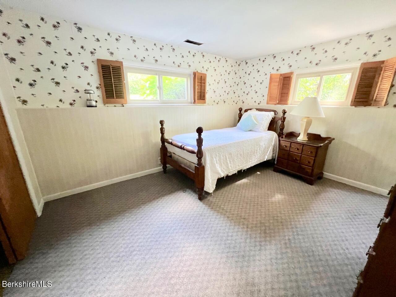 72 Brunell Avenue Lenox, MA 01240 - Photo 10 of 27 a spacious bedroom with a bed and a window