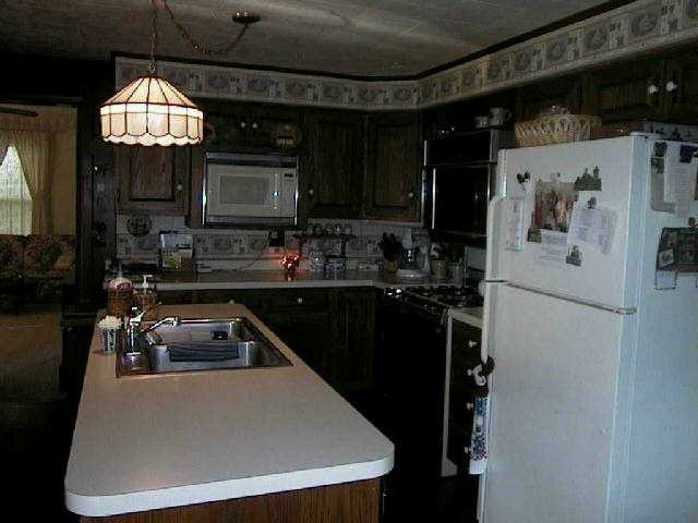11835 Grange Road Lanark, IL 61046 - Photo 4 of 9 a kitchen with refrigerator and window