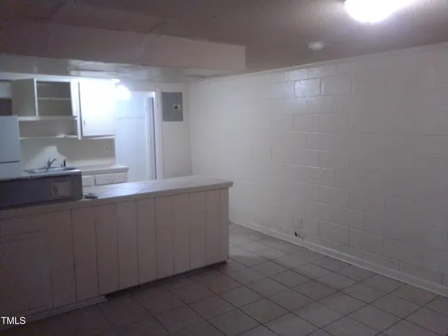 a room with a sink and cabinets