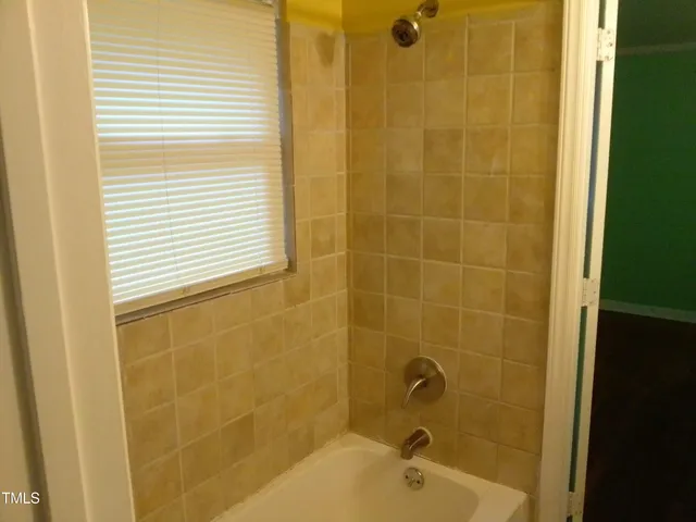 a bathroom with a shower and a bathtub