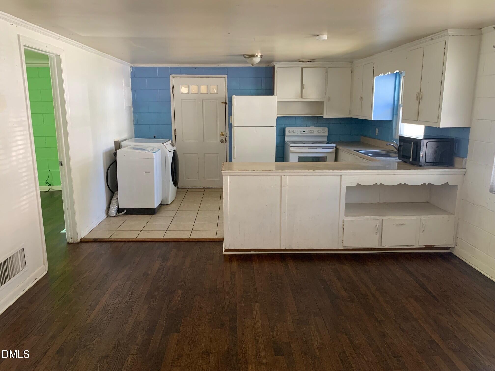 2205 Lafayette Street Durham, NC 27707 - Photo 16 of 17 a living room with stainless steel appliances wooden floors and view kitchen