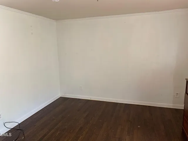 an empty room with wooden floor