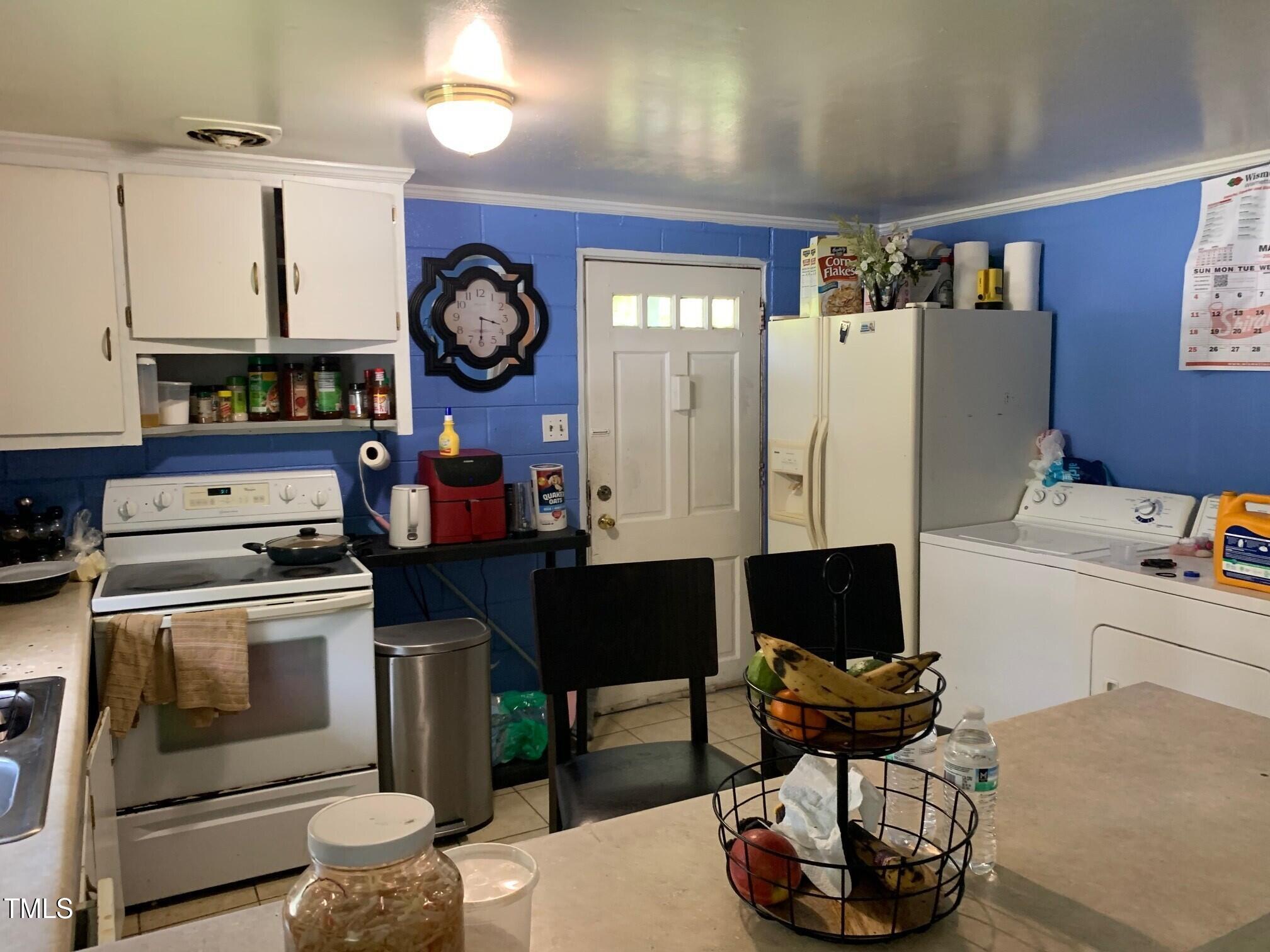 2205 Lafayette Street Durham, NC 27707 - Photo 8 of 17 a living room with furniture a clock and a fireplace