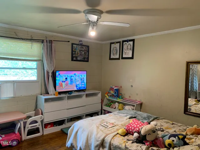 a bedroom with bed and a window