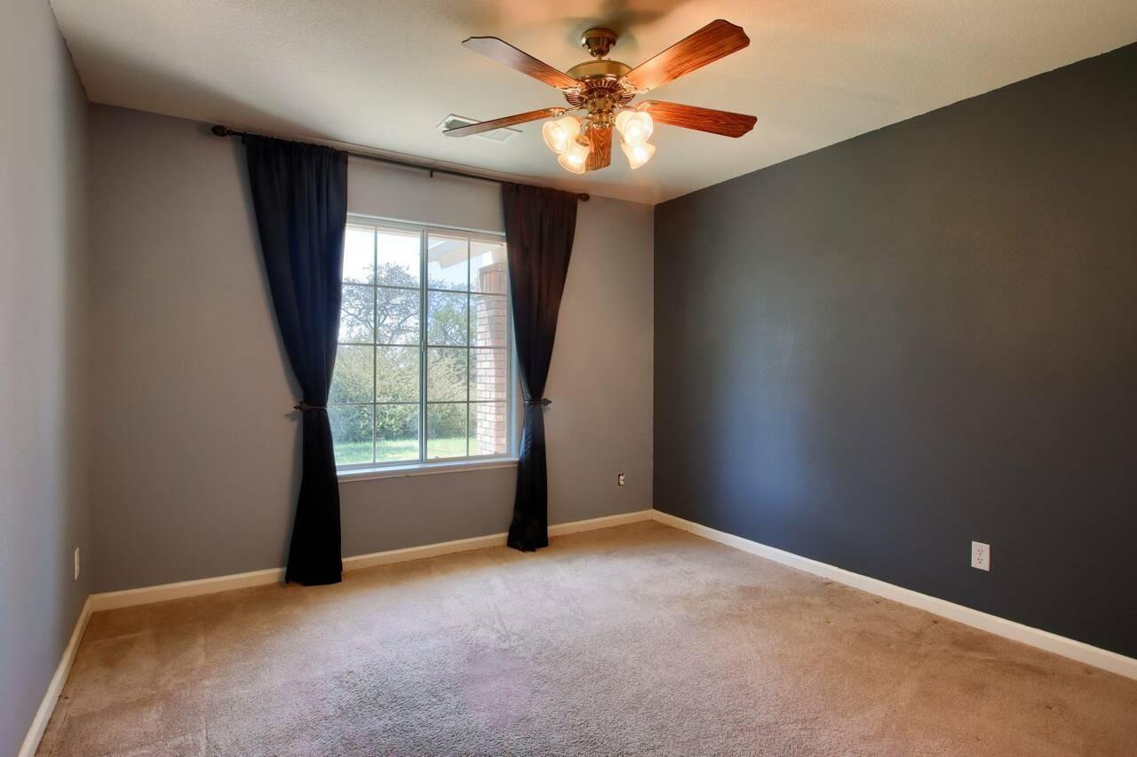 46911 Veater Ranch Road Coarsegold, CA 93614 - Photo 20 of 41 an empty room with windows and fan