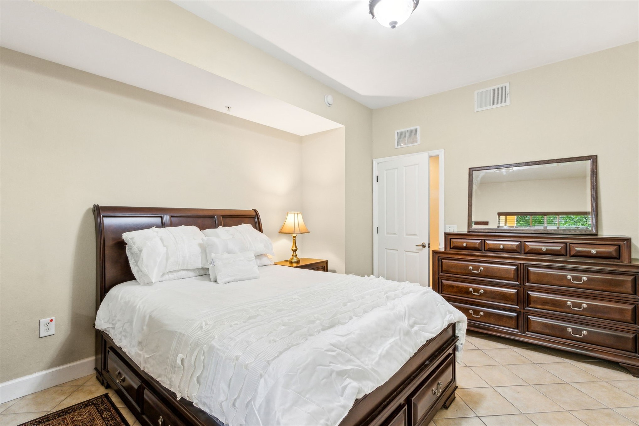 9745 Touchton Road Jacksonville, FL 32246 - Photo 9 of 20 a bedroom with a bed and a flat tv screen on dresser