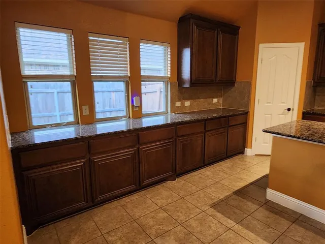 a kitchen with stainless steel appliances granite countertop wooden cabinets a sink and dishwasher