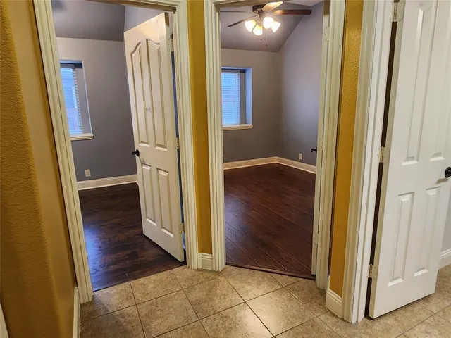 an empty room with wooden floor and a bathroom