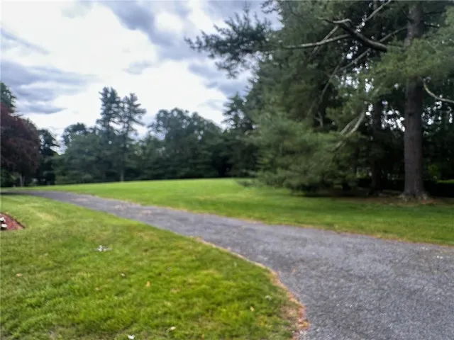 a view of a field of grass and trees