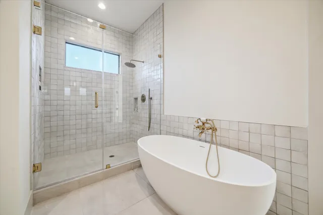 a bathroom with a bathtub and shower