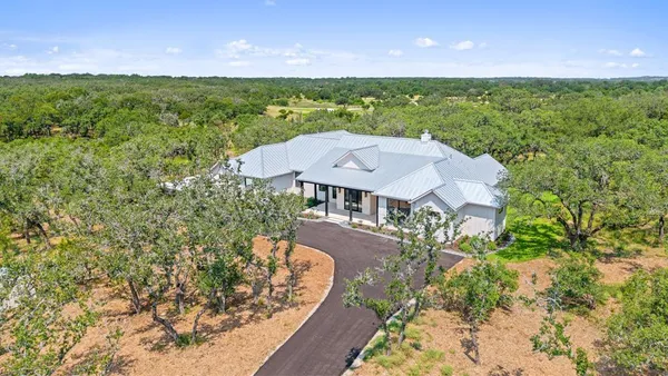 an aerial view of a house with big yard