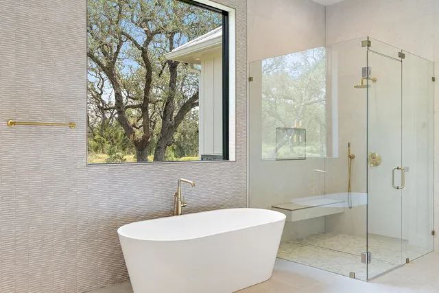 a bathroom with a bathtub and shower