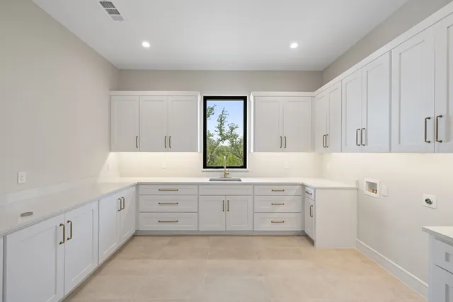 a bathroom with a granite countertop sink mirror and a toilet