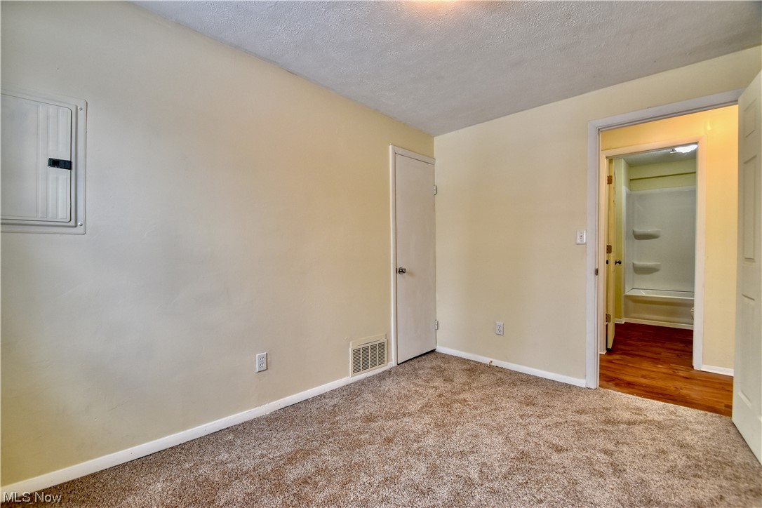 1512 Hubbard Road Madison, OH 44057 - Photo 10 of 27 Unfurnished bedroom with a textured ceiling and light colored carpet