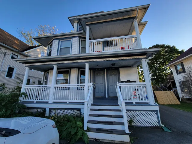 a front view of a house with entryway and deck