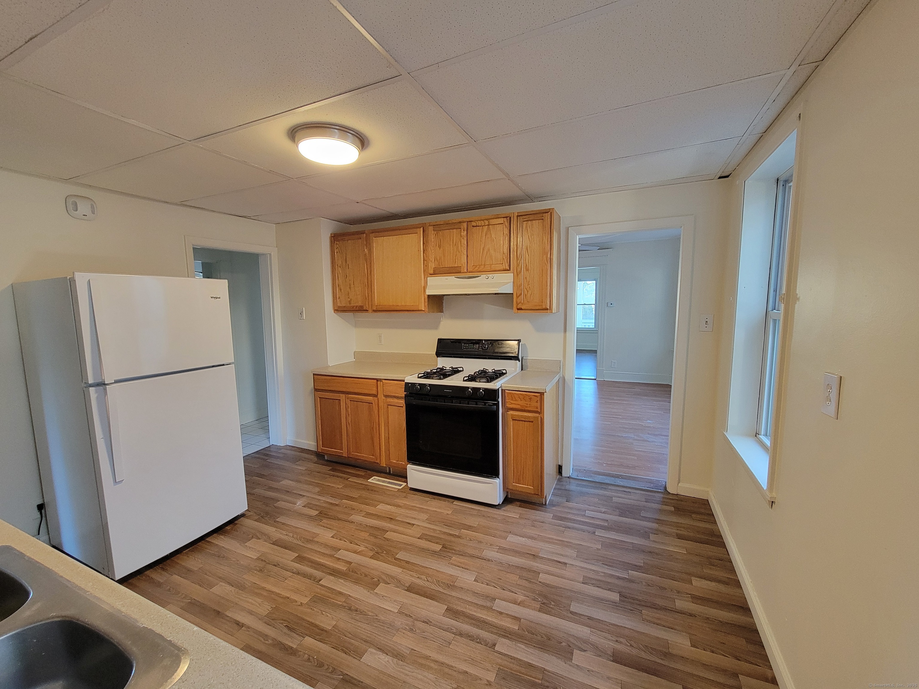 138 Federal Street Bristol, CT 06010 - Photo 11 of 17 a kitchen with a refrigerator and a stove