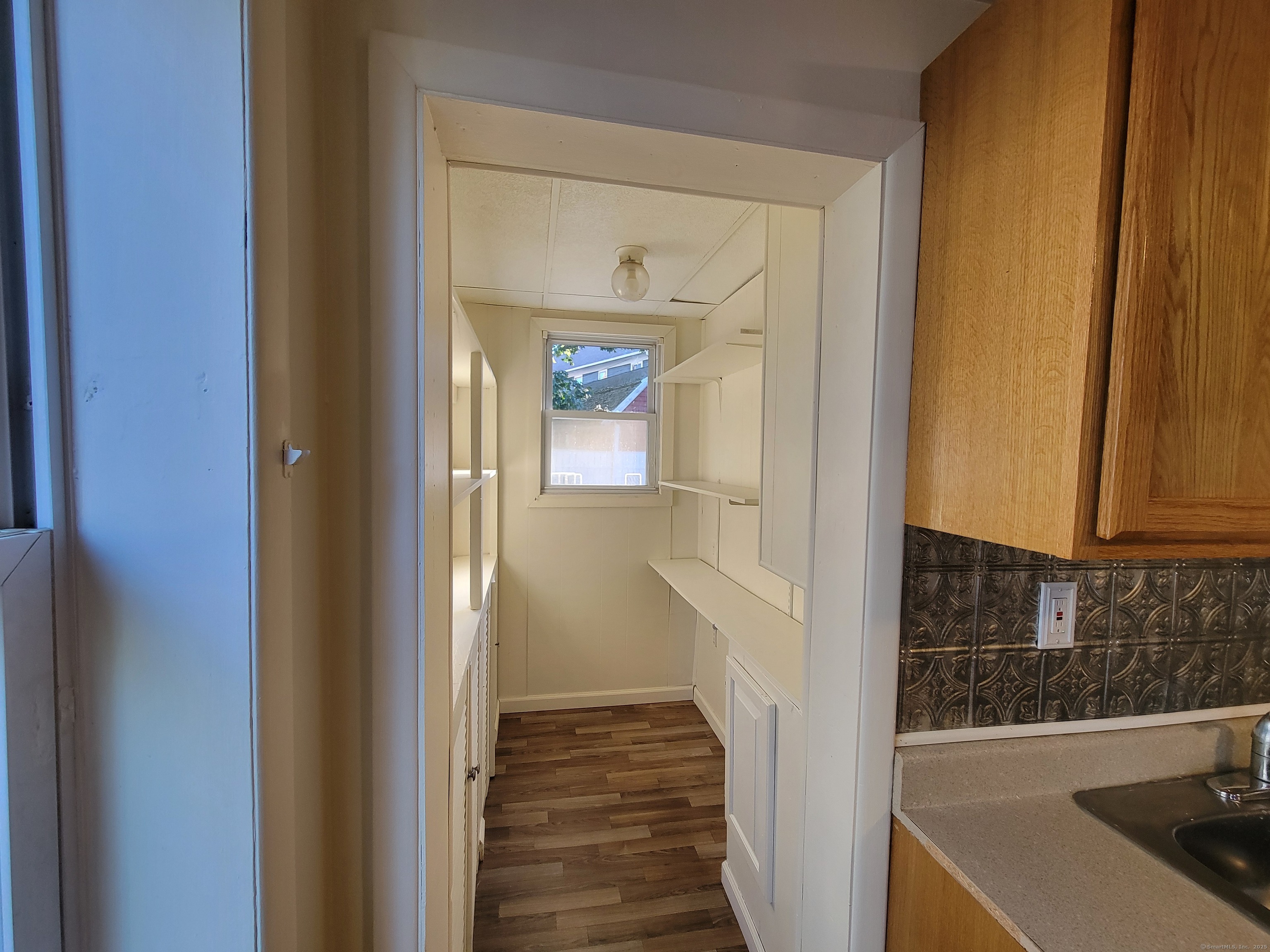 138 Federal Street Bristol, CT 06010 - Photo 12 of 17 a view of a hallway with wooden cabinets and entryway