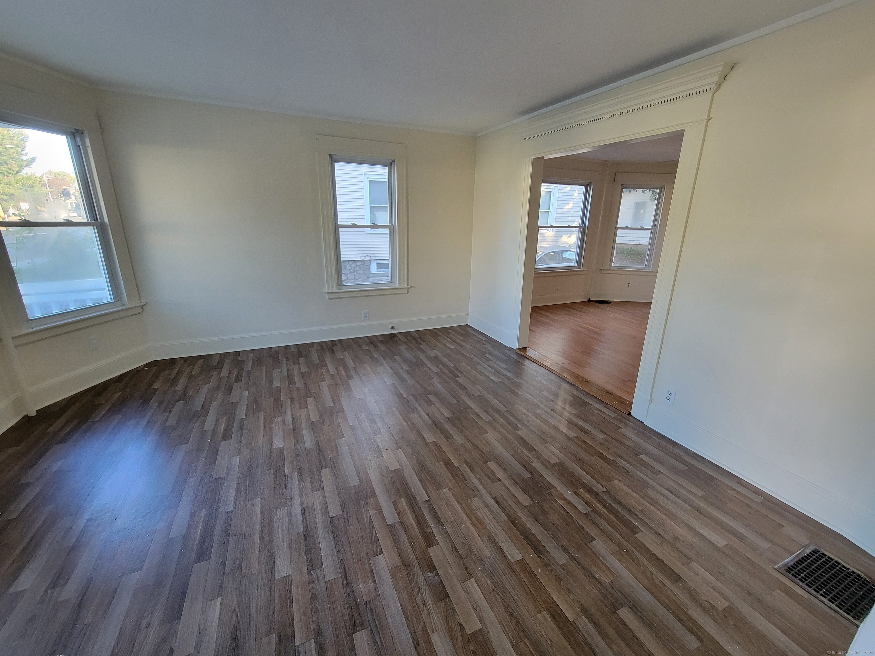 138 Federal Street Bristol, CT 06010 - Photo 6 of 17 an empty room with wooden floor and windows