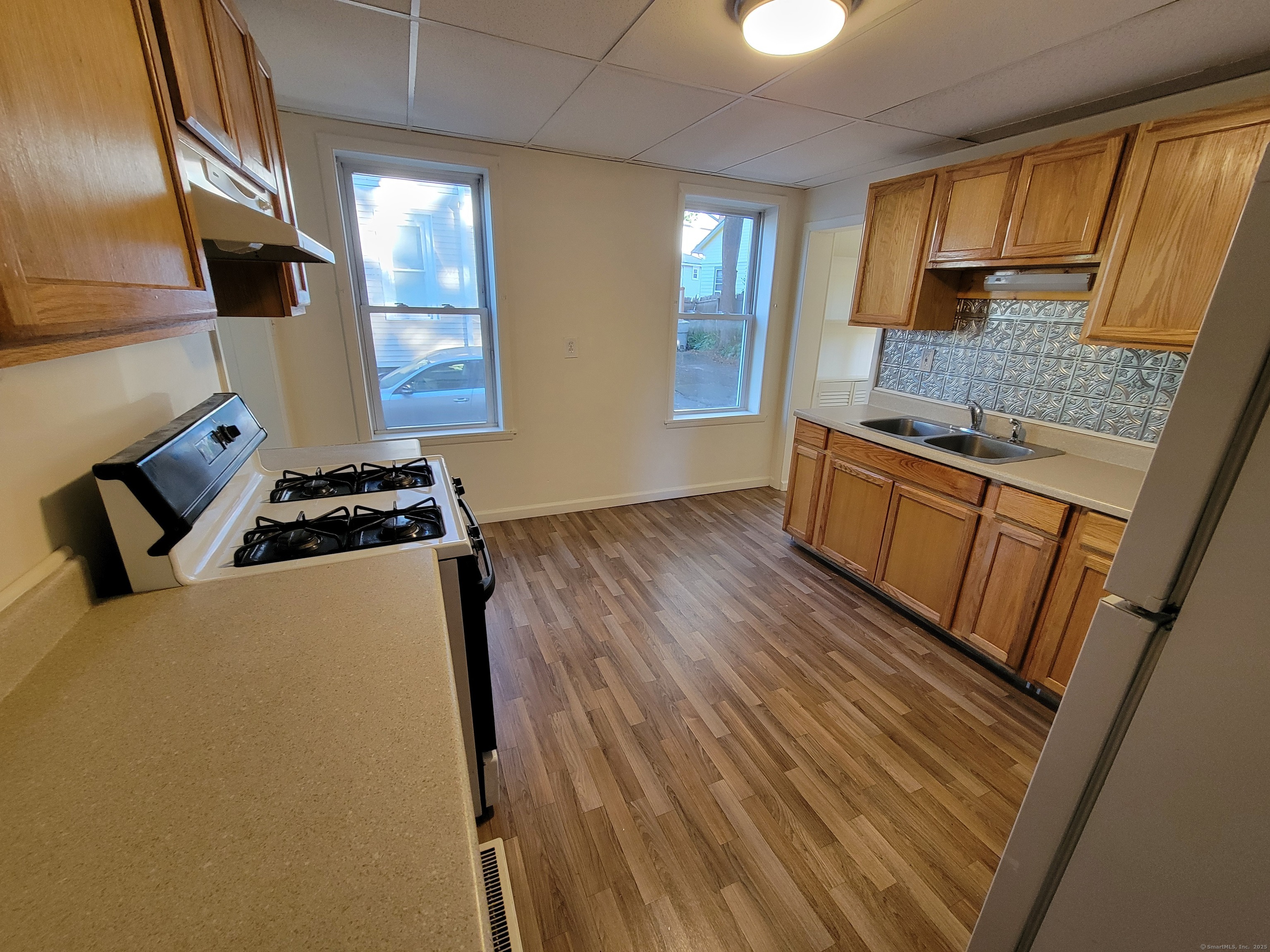 138 Federal Street Bristol, CT 06010 - Photo 10 of 17 a kitchen with granite countertop a sink stove and cabinets