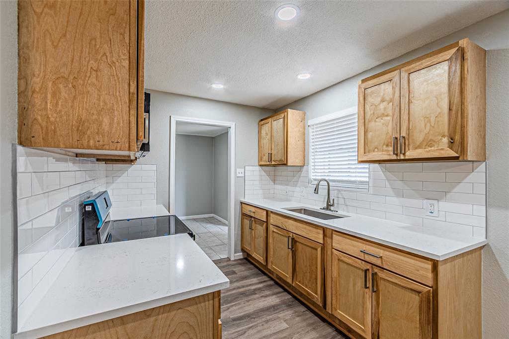 1205 Navaho Street Arlington, TX 76012 - Photo 6 of 18 a kitchen that has a sink and a stove in it