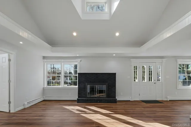 an empty room with windows and a fireplace