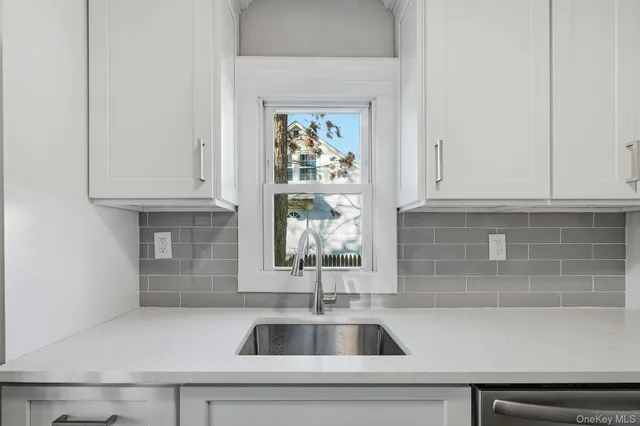 a kitchen with a sink and cabinets