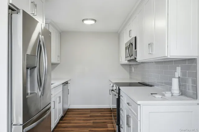 a kitchen with stainless steel appliances a refrigerator and a sink