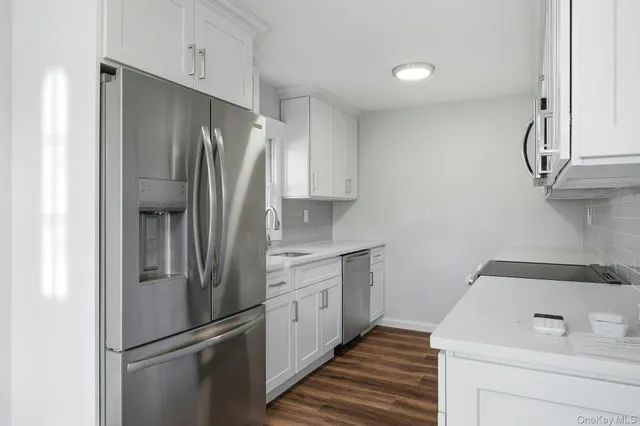 a kitchen with stainless steel appliances a refrigerator and a sink