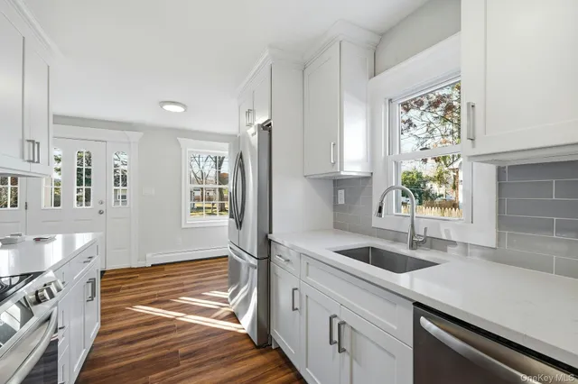 a kitchen with stainless steel appliances granite countertop a sink and a stove